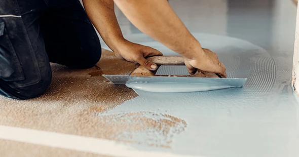 Craftsman repairing epoxy flooring in Boulder, Colorado.