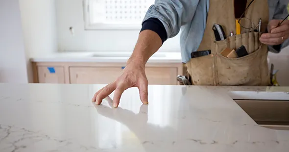 Craftsman inspecting custom epoxy countertop in Winchester, Virginia.