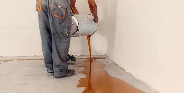Epoxy floor being installed by professional wearing work clothing in Morgantown, WV.