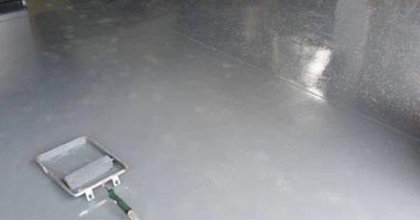 Epoxy surface refinishing with squeegee tool in Aurora, Colorado.