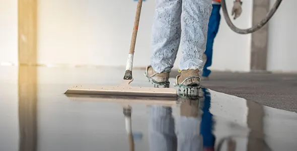 Workers installing epoxy flooring.